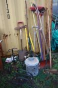 A QUANTITY OF GARDEN TOOLS to include rakes, a scarifier and yard brushes together with a metal