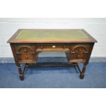 AN REPRODUCTION OAK OLD CHARM STYLE LADIES DESK, with a green leather tooled inlay, a central drawer