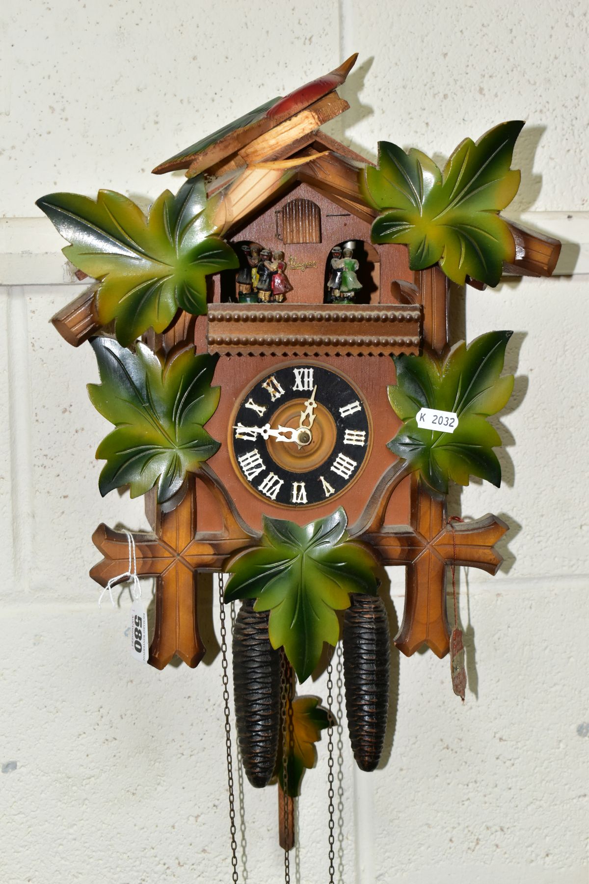 A FORESTALL CUCKOO CLOCK, with dancing couples, pinecone weights and original tag (Condition report: