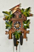 A FORESTALL CUCKOO CLOCK, with dancing couples, pinecone weights and original tag (Condition report: