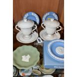 A PAIR OF 19TH CENTURY WEDGWOOD WHITE BISQUE TWIN HANDLED LEMONADECUPS, COVERS AND STANDS AND FOUR