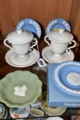 A PAIR OF 19TH CENTURY WEDGWOOD WHITE BISQUE TWIN HANDLED LEMONADECUPS, COVERS AND STANDS AND FOUR