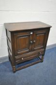 AN ERCOL TWO DOOR CABINET, with a single drawer, width 79cm x depth 44cm x height 88cm