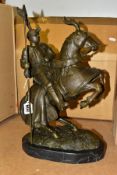 A BOXED REPRODUCTION BRONZE OF A JOUSTING KNIGHT ON HORSEBACK on a marble style plinth,