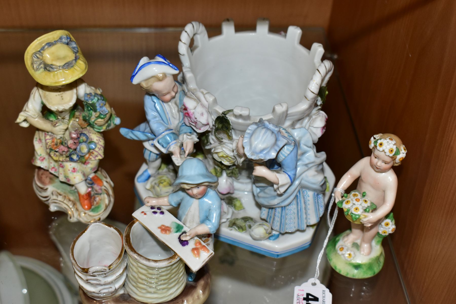 A GROUP OF FOUR 19TH AND 20TH CENTURY PORCELAIN FIGURES, comprising a figure of a putti with - Image 6 of 7