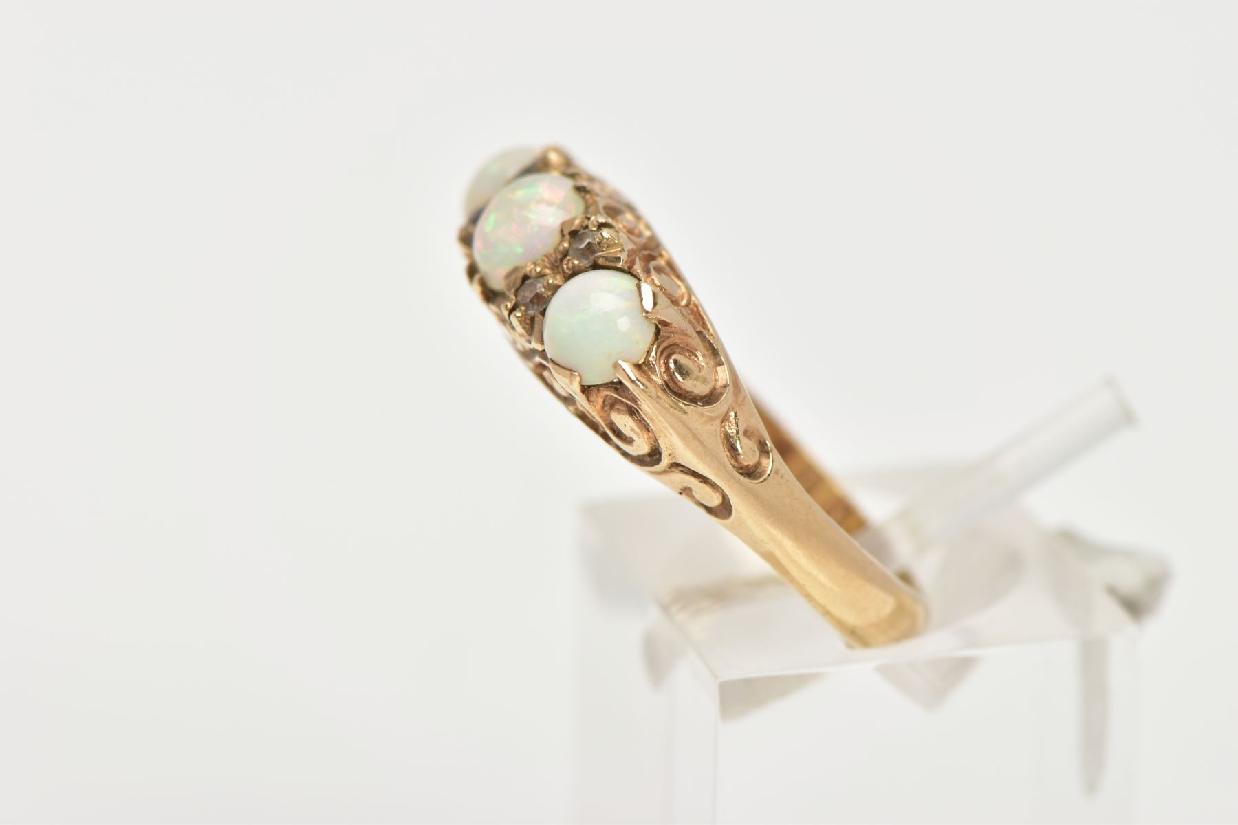 A THREE STONE OPAL RING, three circular opals set in a raised mount with scrolling detail, - Image 2 of 4