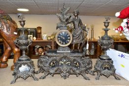 A LATE 19TH CENTURY BRONZED SPELTER AND BLACK SLATE CLOCK GARNITURE, the mantel clock with figure of