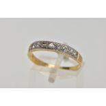 A YELLOW METAL DIAMOND HALF ETERNITY RING, designed with a row of nine round brilliant cut diamonds,