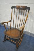 A STAINED BEECH SPINDLED ROCKING CHAIR