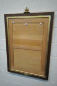 AN OAK AND GILT FRAMED PICTURE FRAME with a glass plate and crown surmount, 79cm x 116cm