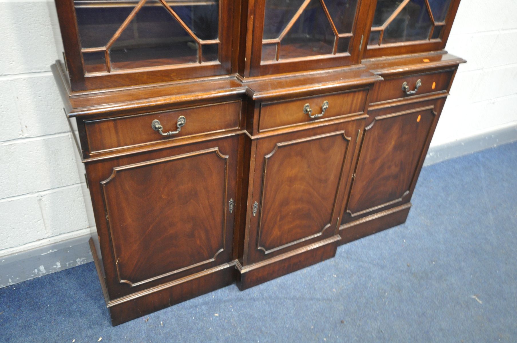 A REPRODUCTION MAHOGANY TRIPLE DOOR BREAKFRONT BOOKCASE, over three drawer and three cupboard doors, - Image 3 of 3