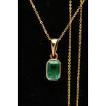 AN EMERALD PENDANT AND CHAIN, an emerald cut emerald, measuring approximately 7mm x 5mm, bezel set