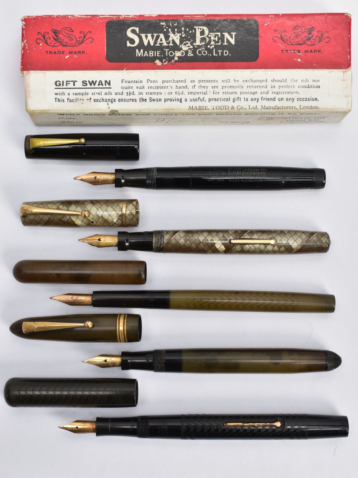 FIVE VINTAGE SWAN FOUNTAIN PENS BY MABIE TODD AND CO. comprising of a boxed black Leverless (