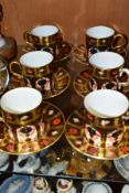 A SET OF SIX ROYAL CROWN DERBY SOLID GOLD BAND IMARI COFFEE CANS AND SAUCERS IN THE 1128 PATTERN,