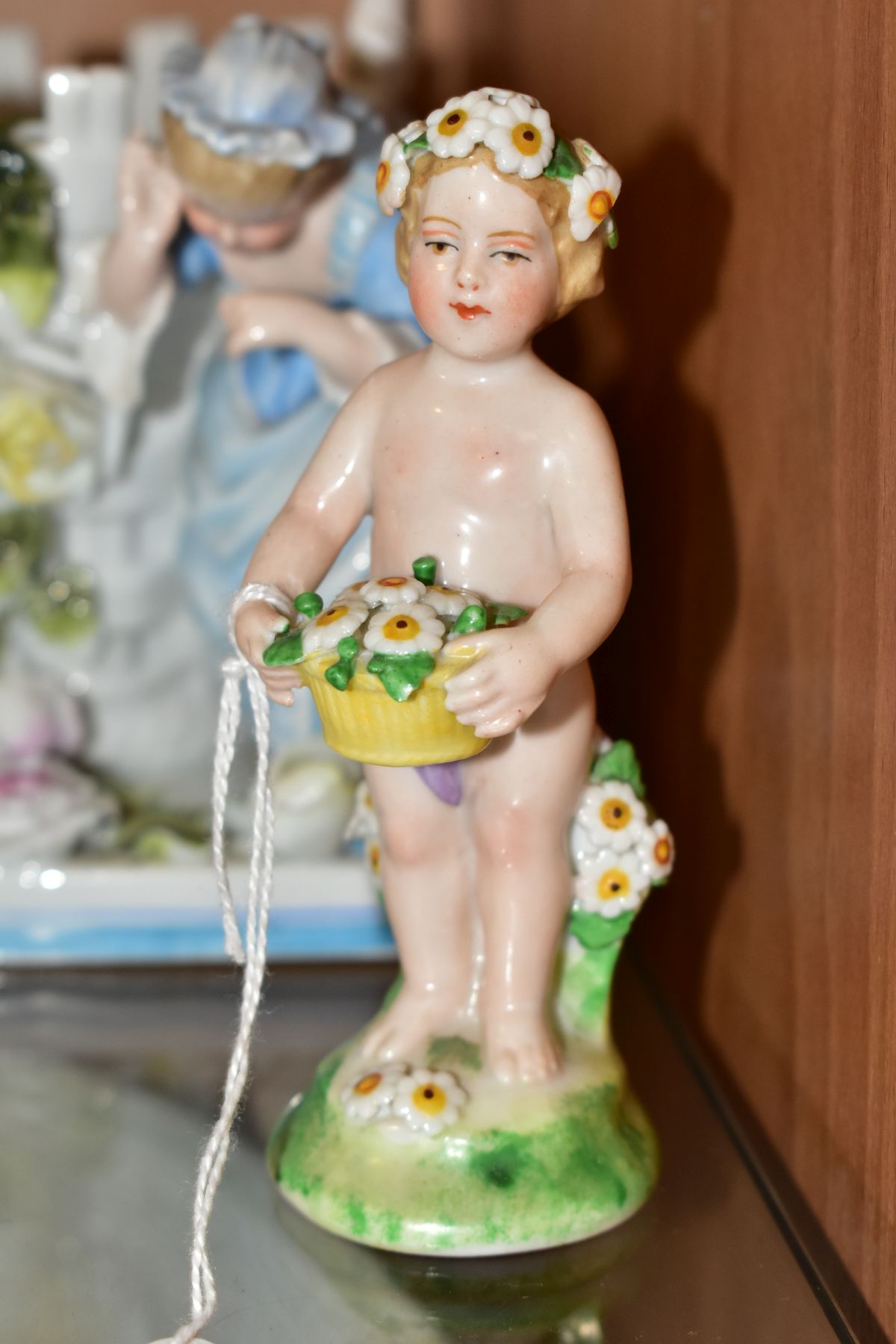 A GROUP OF FOUR 19TH AND 20TH CENTURY PORCELAIN FIGURES, comprising a figure of a putti with - Image 2 of 7