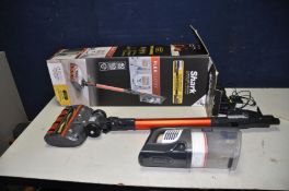A SHARK CORDLESS VACUUM CLEANER with battery, charger and accessories in box (spares or repairs as