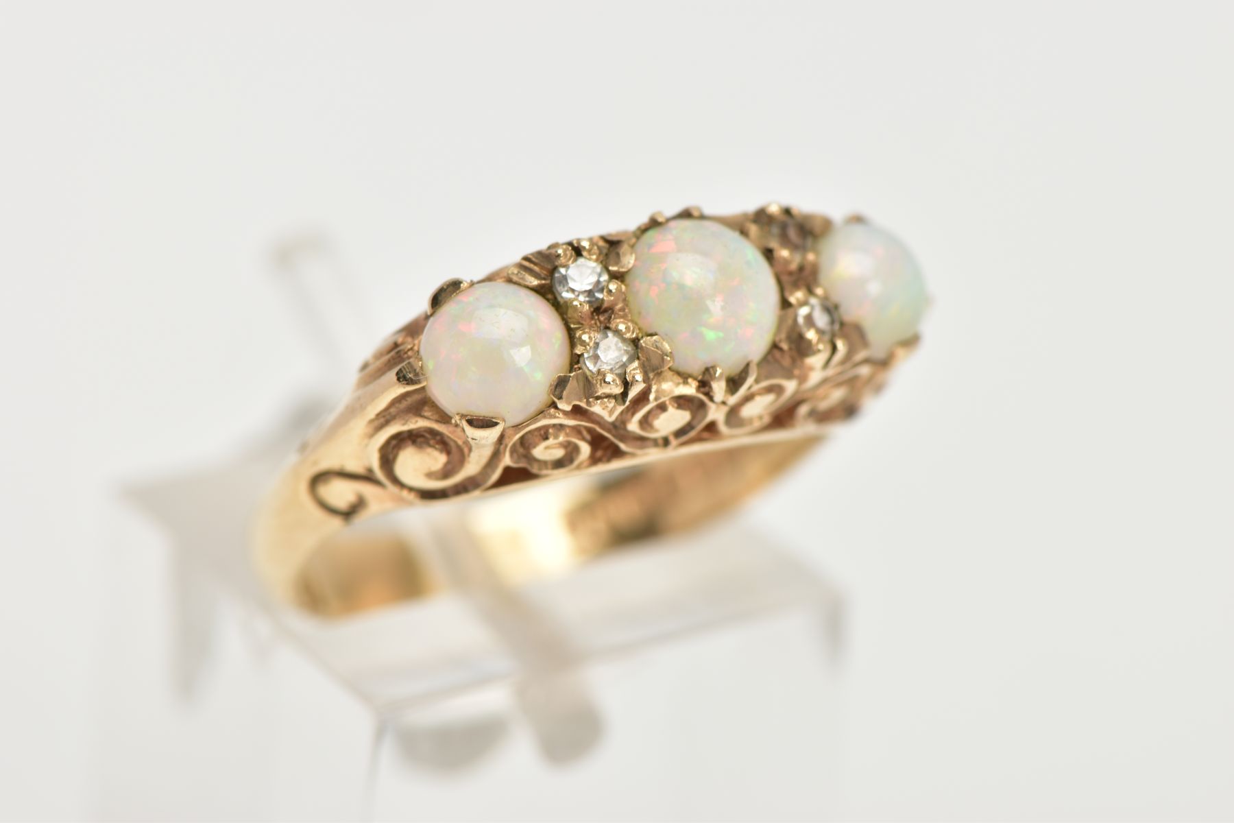 A THREE STONE OPAL RING, three circular opals set in a raised mount with scrolling detail, - Image 4 of 4