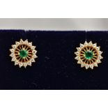 A PAIR OF 18CT GOLD EMERALD AND DIAMOND EARRINGS, each of an openwork circular design, centring on a