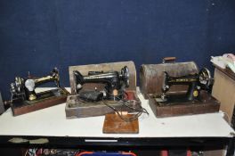 THREE VINTAGE SINGER SEWING MACHINES, two with distressed domed cases (one key) one electric but