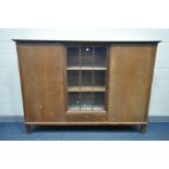 AN EARLY 20TH CENTURY OAK TRIPLE DOOR BOOKCASE, the outer two doors with shelving and three drawers,