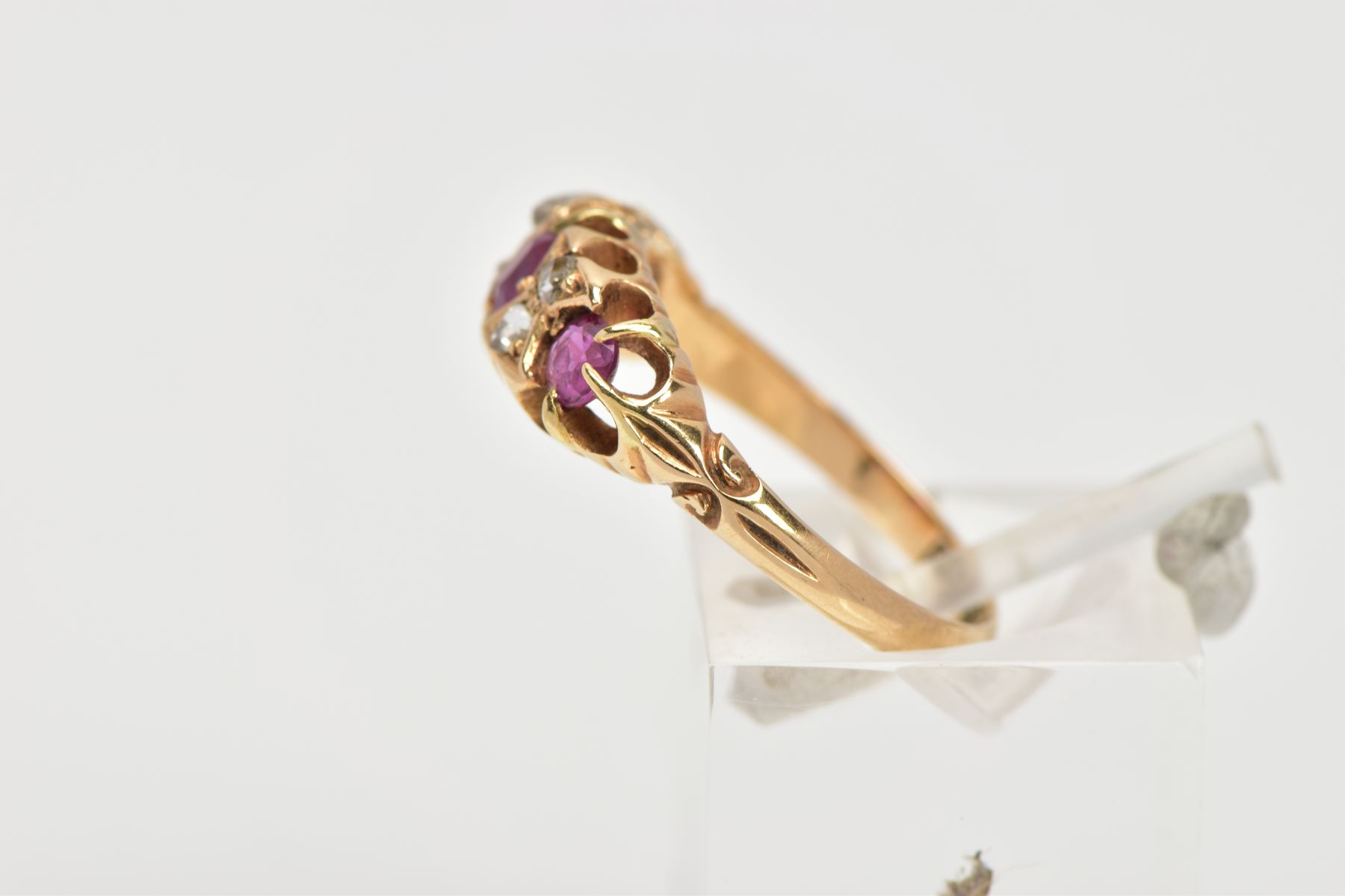 AN EARLY 20TH CENTURY RUBY AND DIAMOND RING, 18ct gold ring set with one cushion cut ruby and two - Image 2 of 4