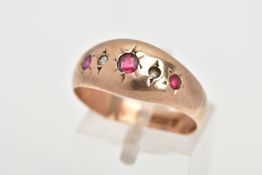 AN EARLY 20TH CENTURY 9CT GOLD GYSPY RING, designed with three star set, circular cut red stones the