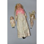 A LATE NINETEENTH CENTURY WAX HEAD DOLL WITH TWO SMALL BISQUE HEAD DOLLS, comprising larger,