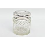 A GLASS AND SILVER LIDDED VANITY JAR, moulded glass pattern, the lid has a decorative floral rim,