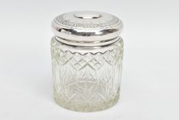 A GLASS AND SILVER LIDDED VANITY JAR, moulded glass pattern, the lid has a decorative floral rim,