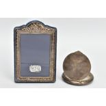 A SILVER PHOTO FRAME AND A WHITE METAL COMPACT, the small photo frame of a rectangular form with