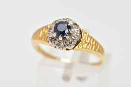 AN 18CT GOLD SAPPHIRE AND DIAMOND CLUSTER RING, centring on an eight claw set, circular cut blue