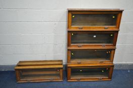 AN EARLY 20TH CENTURY OAK FIVE PIECE SECTIONAL BOOKCASE, with hide and fall glass doors, no base and