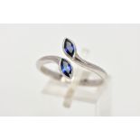 AN 18CT WHITE GOLD SAPPHIRE RING, of a cross over design, set with two marquise cut blue sapphires