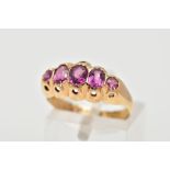 AN EARLY 20TH CENTURY AMETHYST RING, set with three oval cut amethysts and two circular cut