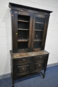A DISTRESSED OAK BOOKCASE, with two drawers, width 107cm x depth 45cm x height 200cm