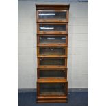 AN EARLY 20TH CENTURY OAK SEVEN PIECE SECTIONAL BOOKCASE, with hide and fall glass doors, width 87cm