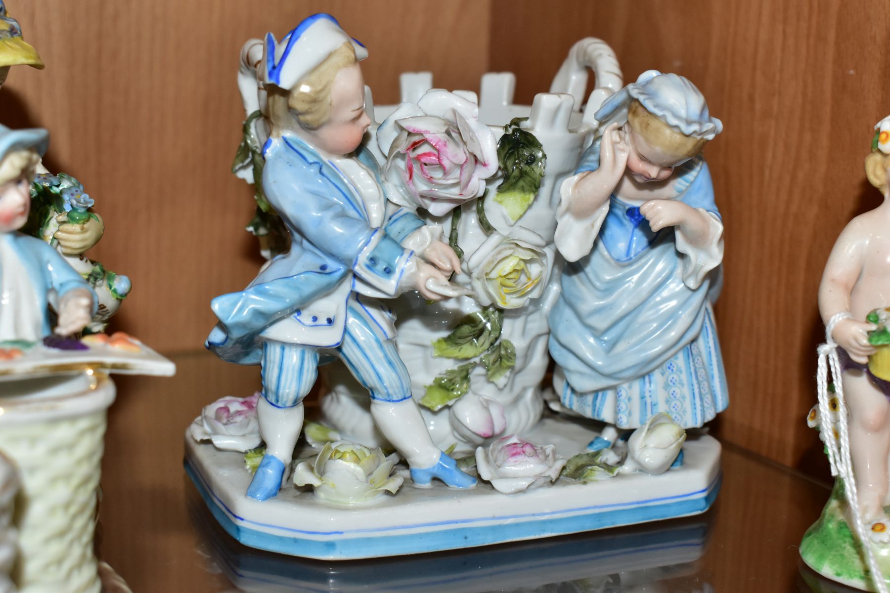 A GROUP OF FOUR 19TH AND 20TH CENTURY PORCELAIN FIGURES, comprising a figure of a putti with - Image 5 of 7