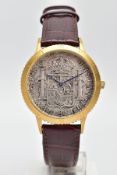 A GENTS WRISTWATCH, with a coin face inscribed information on the back, fitted with a brown