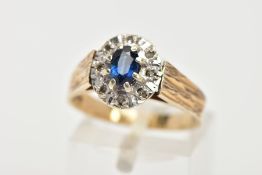 A 9CT GOLD SAPPHIRE RING, designed with an oval cut blue sapphire, prong set, within a halo surround