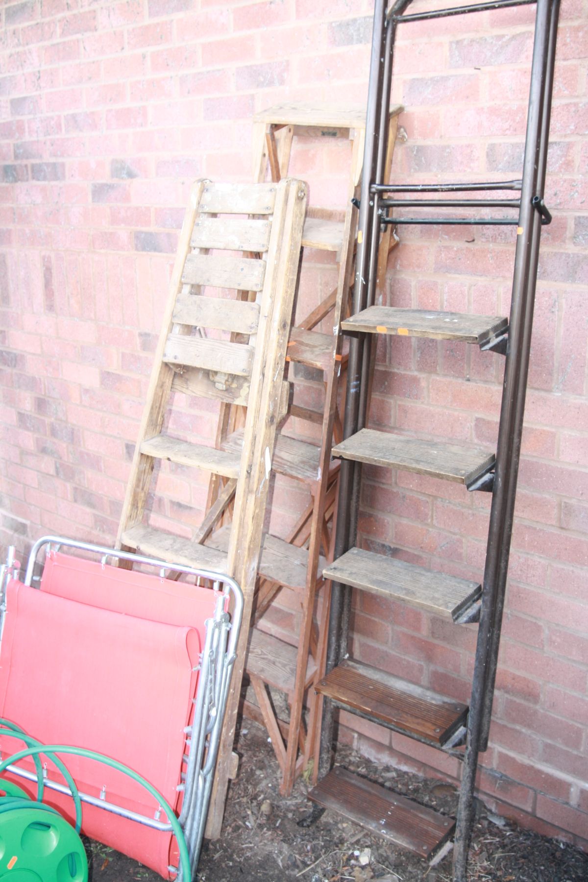 A SET OF METAL TUBULAR FRAMED STEP LADDERS, height 209cm, two sets of wooden step ladders, height
