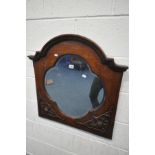 AN EARLY 20TH CENTURY OAK WALL MIRROR, with a quatrefoil bevelled edge plate, and blind fretwork