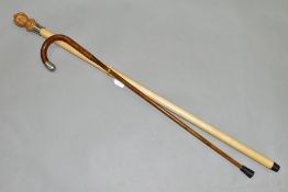 TWO WALKING STICKS, comprising a modern walking cane with carved male mask finial, length 95cm and