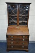 A GEORGIAN MAHOGANY BUREAU BOOKCASE, of deep proportions, the top section with double geometric