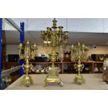 THREE BRASS CANDELABRA, one large candelabrum with five branches around a central sconce, the stem