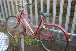 A RED TRIUMPH TRAFFIC MASTER LADIES BICYCLE, 21 inch frame, three speed Sturmey-Archer gears and a