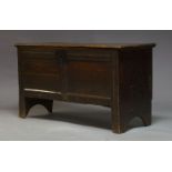 An oak coffer, early 18th Century, the hinged lid enclosing candle box and storage space, raised