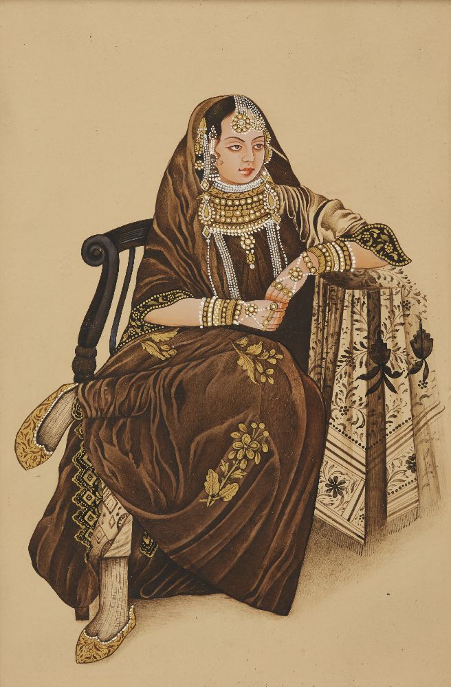 A 20th century oil on panel portrait of a seated lady wearing a brown Sari, against a plain cream