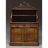 A Victorian mahogany credenza, the raised back with shaped and carved top, above two shelves, on