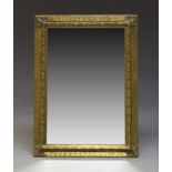 A gilt wall mirror, late 20th Century, of rectangular form, with bevelled plate set within ripple