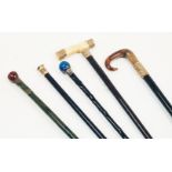 A group of five walking canes, late 19th / early 20th century, to include an ebonised example with